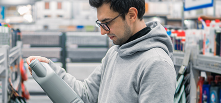 man in grey hoodie choosing oilt